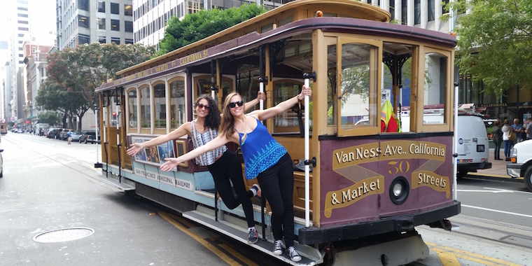 Author Allison with friend and co-worker Nicole standing on a SF trolley